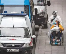  ?? AFP ?? A medical staff pushes a woman on a wheelchair at a hospital for the Covid-19 infected patients in Moscow.