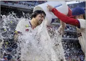  ?? LAURENCE KESTERSON — THE ASSOCIATED PRESS ?? The Phillies' Nick Castellano­s, left, is doused by teammates Bryson Stott, right, and Brandon Marsh, center, after hitting a walk-off single in the ninth inning against the Pirates on Saturday in Philadelph­ia.