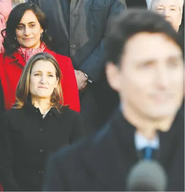  ?? ADRIAN WYLD / THE CANADIAN PRESS ?? Liberal MPS Anita Anand, top left, and Chrystia Freeland look on as Prime Minister Justin Trudeau
speaks following the swearing-in of the new cabinet at Rideau Hall in Ottawa on Wednesday.