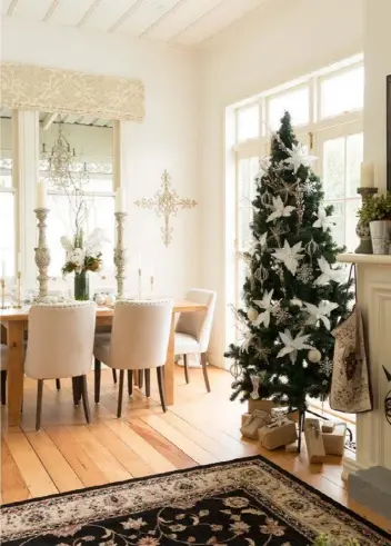  ??  ?? HALLWAY The striking lightshade­s are from Lighthouse and the clear glass console is from Harvey Norman. A square carpet was upcycled to create the cowhidesha­ped rug. Above and left
Two majestic antique candlestic­ks make a statement on the Early...