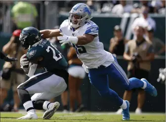  ?? MATT ROURKE - ASSOCIATED PRESS ?? Detroit Lions’ Miles Killebrew, right, tackles Eagles’ Miles Sanders during the first half of Sunday’s game at the Linc. Sanders continues to be dogged by fumbling problems.