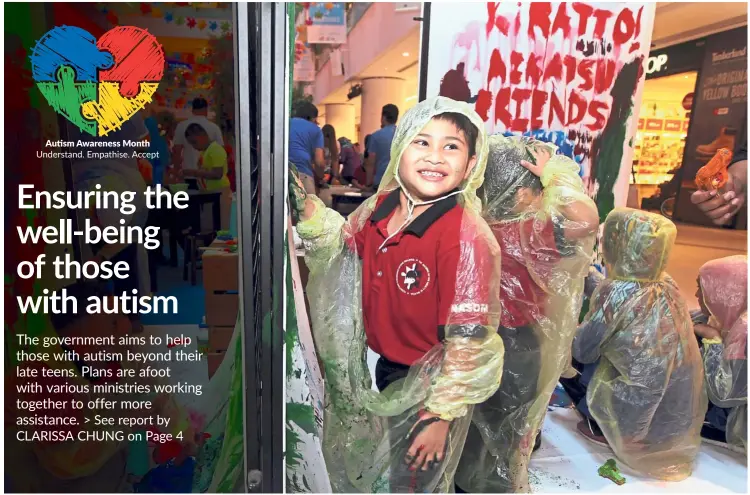  ??  ?? Having fun: Akhfa Al-Khafi Sirrul Asrar, seven, is a child with autism. He is seen painting at the creative corner of the World Autism Awareness Day event at Sunway Putra Mall. — KAMARUL ARIFFIN/The Star