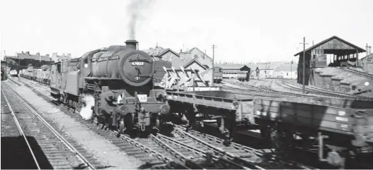  ?? John Pedelty/ARPT ?? Carlisle (Citadel) was a magnet for enthusiast­s, so much so that many of the surroundin­g yards largely failed to get any enthusiast attention, but this view does record London Road yard from a Carlisle-bound train, and seemingly after Ivatt ‘4MT’ 2-6-0 No 43027 reached Carlisle (Kingmoor) in July 1960. The Mogul appears to be making up a train, or is just being called upon to take a Conflat and container somewhere, with the required brake van. The two rakes of wagons are alongside the partly obscured the ex-NER goods shed, its diesel pilot glimpsed alongside, and the land between the nearby 16 ton mineral wagon had a 50ft turntable. To its right, the elevated coal stage had watering facilities on the far side, so outside the double-roundhouse, which by this time was largely used for wagon repairs. The 1880s saw the North Eastern Railway upgrade the locomotive and goods facilities here, but the former fell out of favour post-1925 after a regional boundary change saw London Road become part of the LNER Scottish Southern Area.