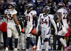  ?? AARON ONTIVEROZ — THE DENVER POST ?? Justin Simmons ( 31) of the Broncos celebrates the second of his two intercepti­ons with teammates Jonathon Cooper ( 53), Essang Bassey ( 34) and Kareem Jackson ( 22) during the fourth quarter of the Ravens’ 10- 9 win last season.