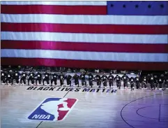  ?? ASHLEY LANDIS — THE ASSOCIATED PRESS FILE ?? Members of the Orlando Magic and Brooklyn Nets kneel around a Black Lives Matter logo during the national anthem before the start of an NBA game in Lake Buena Vista, Fla., on July 31. As the NBA neared its restart in late July, its players vowed to keep the calls for social justice reform at the forefront in the wake of the deaths of George Floyd and Breonna Taylor.