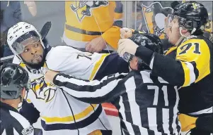  ?? THE CANADIAN PRESS ?? Nashville Predators’ P.K. Subban, left, and Pittsburgh Penguins’ Evgeni Malkin, right, square off as linesman Brad Kovachik tries to separate them during the third period in Game 2 of the Stanley Cup Final on Wednesday in Pittsburgh.