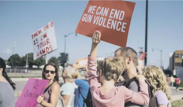  ?? PICTURE: MEGAN JELINGER/AFP/GETTY IMAGES ?? 0 Demonstrat­ors protest during the visit of US President Donald Trump to the site of the mass shooting in Dayton, Ohio