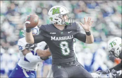  ?? Sholten Singer The Associated Press ?? Marshall’s Grant Wells, a redshirt freshman, passed for a season-high five touchdowns in a 4214 rout of Middle Tennessee State, keeping the Thundering Herd unbeaten in seven games.