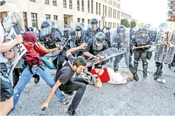  ??  ?? File photo show protesters fall as they are pushed back by police in riot gear during a protest after a not guilty verdict in the murder trial of Stockley in St. Louis, Missouri, US. — Reuters photo