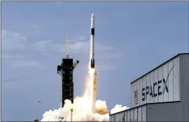  ?? JOHN RAOUX — THE ASSOCIATED PRESS FILE ?? On May 30, a SpaceX Falcon 9 with NASA astronauts Doug Hurley and Bob Behnken in the Dragon crew capsule lifts off from Pad 39-A at the Kennedy Space Center in Cape Canaveral, Fla.