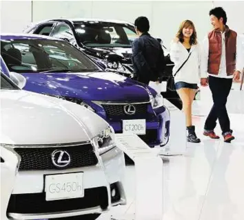  ??  ?? AP Lexus models at a Toyota showroom in Tokyo. Toyota sales raced to a record 9.748 million last year, allowing it to wrest back the title of the world’s biggest automaker from General Motors.