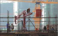  ?? ZHOU CHANGGUO / FOR CHINA DAILY ?? Workers at the constructi­on site of a property project in Huai’an, Jiangsu province.