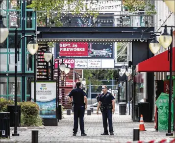  ?? MARK WALLHEISER / GETTY IMAGES ?? Jacksonvil­le sheriff’s officers patrol Jacksonvil­le Landing on Sunday after the mass shooting at the “Madden NFL 19” video game tournament. The contest was being live-streamed on the Twitch service.