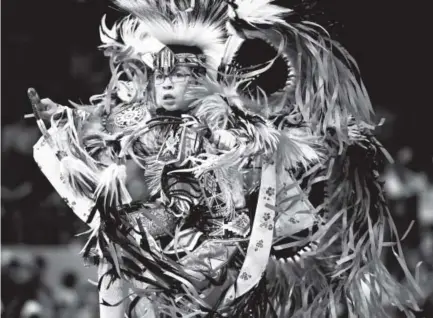  ??  ?? Timothy Gabbard, 10, of Moorhead, Minn., and a member of the Dakota Tribe, dances during the Jr. Boys Fancy Bustle Dance during the Denver March Powwow at the Denver Coliseum on Saturday. Photos by Joe Amon, The Denver Post