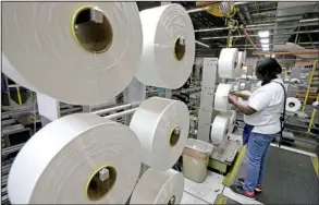  ?? AP/CHUCK BURTON ?? An employee at the Repreve Bottle Processing Center in Yadkinvill­e, N.C., examines a spool of thread made from recycled plastic bottles in this file photo. A measure of American worker productivi­ty increased in the third quarter, the Labor Department...