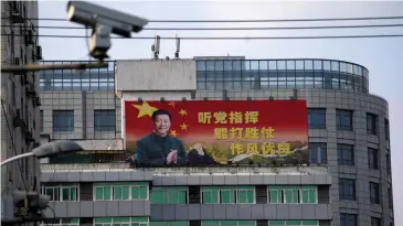  ?? REUTERS ?? A poster with a portrait of Chinese President Xi Jinping is displayed in Shanghai. With China’s parliament abolishing presidenti­al term limits, Mr Xi could rule China indefinite­ly.