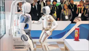  ?? AP PHOTO ?? The Walker robot grabs a soda can during a demonstrat­ion at the Ubtech booth at CES Internatio­nal Wednesday.