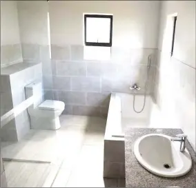  ?? ?? This en suite bathroom provides the perfect adult space for you to relax and unwind in private, it offers a shower, bathtub and double vanity.