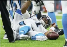  ?? SCOTT CLAUSE — THE DAILY ADVERTISER VIA AP ?? Carolina Panthers quarterbac­k Cam Newton lies on the field after being sacked during an NFL NFC wild-card playoff football game against the New Orleans Saints on Sunday in New Orleans. New Orleans won 3126.