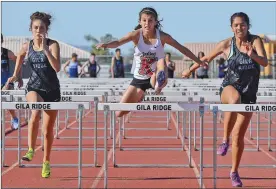  ??  ?? ABOVE: KOFA’S KAREN RIVAS (CENTER) leads the field in the girls 100-meter hurdles event Tuesday afternoon at Gila Ridge. Rivas would get the win. RIGHT: Cibola’s Thomas Cain (right) keeps an eye on teammate Jake Smith as the two lead the field through...