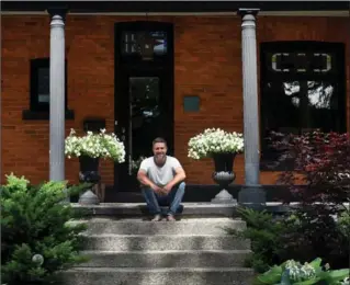  ??  ?? Amos Connolly on the front steps of his west Hamilton home. “I’ve enjoyed the process of taking this house and making it my own; that was pretty organic for me," he says. "But all of this, all of the things I’ve made, staying in this house, the design...