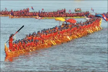  ?? TANG CHHIN SOTHY / AFP ?? The world’s longest dragon boat carrying 179 rowers sail along the Mekong River during a ceremony in Prey Veng province, Cambodia, on Monday. The country won a place in the Guinness Book of World Records for building the 87.3-meter-long and 1.94-meterwide wooden dragon boat. China set the previous record with a dragon boat that was measured at 77.8 meters long on May 28, 2016.