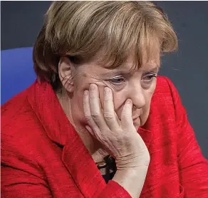  ??  ?? It’s all too much: Mrs Merkel yesterday at the German parliament