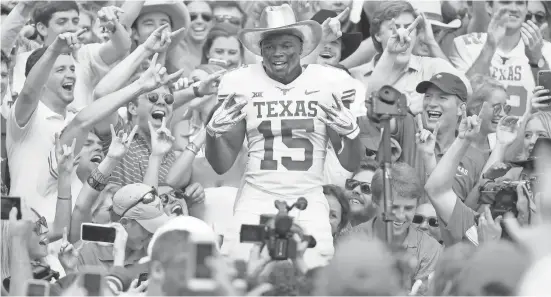  ?? TIM HEITMAN/USA TODAY SPORTS ?? Texas defensive back Chris Brown celebrates in the crowd after the Longhorns defeated Oklahoma in the Big 12 showdown at the Cotton Bowl.