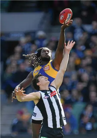  ?? Photo: JULIAN SMITH ?? BIG CONCERN: Nic Naitanui (left) gets the jump on Magpies rival Brody Mihocek before he was forced from the field in yesterday’s clash at the MCG.