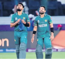  ?? AP ?? Pakistan’s cricket captain Babar Azam (left) and Mohammad Rizwan celebrate after their team won the Twenty20 World Cup match against India.