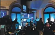  ?? Spencer Platt Getty Images ?? FED Chairman Jerome H. Powell’s news conference is shown on TV at the New York Stock Exchange.