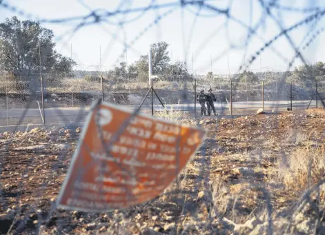  ?? ?? Israeli army soldiers guard a section of Israel’s separation barrier, in the West Bank village of Nilin, west of Ramallah, Palestine, Nov. 7, 2021.