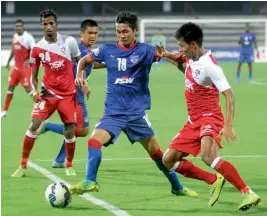  ?? — R. SAMUEL ?? Bengaluru FC’s Siam Hangal ( centre) vies for the ball with DSK Shivajians players in their I- League game in Bengaluru on Wednesday. The hosts won 4- 1.