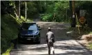  ??  ?? A New York state trooper stands guard outside the home where attorney Roy Den Hollander was found dead in Catskills, New York, on Monday. Photograph: Eduardo Muñoz/Reuters