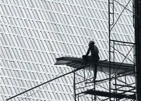  ?? PATIPAT JANTHONG ?? A worker sits on scaffoldin­g at a constructi­on site in Bangkok. The next global recession will have serious effects in Thailand and Southeast Asia, says Sharad Apte.