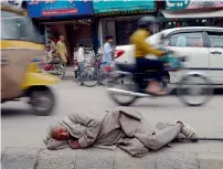  ?? AFP ?? A beggar rests on a footpath at a market in Rawalpindi on Tuesday. The first phase of census will conclude on April 15 and the second will be held from April 25 to May 25, with final results expected by the end of July. —