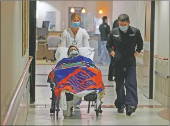  ??  ?? Broward Health nurse Brooke Freeman and Dr. Jose Lozada escort Jose Castro to a news conference.