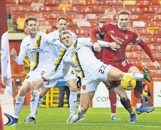  ?? ?? POINT TO PROVE Longridge is sent for an early bath, left, before Bates battles Lions’ defence to force home the second goal at Pittodrie as the Reds close in on top six