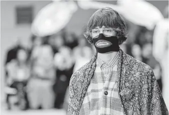  ?? Antonio Calanni / Associated Press file ?? A model wears a Gucci face warmer on the runway in Milan, Italy, in 2018. The item, reminiscen­t of blackface, prompted backlash from the public and forced the company to apologize publicly.