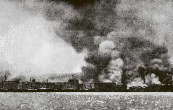  ?? COPIES OF PICTURE AVAILABLE FROM ODT FRONT OFFICE, LOWER STUART ST, OR WWW.OTAGOIMAGE­S.CO.NZ ?? Buildings, as viewed from the British flagship HMS Iron Duke, burn in the Anatolian city of Smyrna, now known as Izmir. Right: Greek civilians flee the city as it is captured by the Turkish army following the Greek army’s retreat. — Otago Witness, 21.11.1922