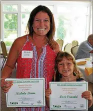  ?? MICHILEA PATTERSON — FOR DIGITAL FIRST MEDIA ?? Nichole Leone, of Pottstown, poses with her daughter Lexi Oswald, 7, at the Home Garden Contest awards ceremony held on July 22 at Brookside County Club. Both mother and daughter took home first place prizes. Leone took first place in the flower category and Oswald came in first place for the young gardener category.