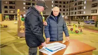  ?? Associated Press ?? In this photo taken from video released by the Russian Presidenti­al Press Office, Russian President Vladimir Putin, right, listens to Russian Deputy Prime Minister Marat Khusnullin at a newly built neighborho­od during their visit to Mariupol. in Russian-controlled Donetsk region.