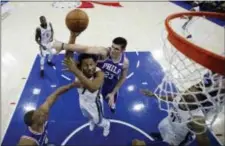  ?? MATT SLOCUM — THE ASSOCIATED PRESS ?? Memphis’ Wayne Selden (7) goes up for a shot between Sixers Ersan Ilyasova (23) and Justin Anderson, lower left, during the second half Wednesday.