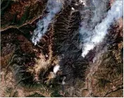  ?? DIGITALGLO­BE ?? This June 9 satellite image shows the 416 Fire (right) and the Burro Fire (left), northwest of Durango, Colo. San Juan National Forest officials in southweste­rn Colorado closed trails and miles of back roads Tuesday.