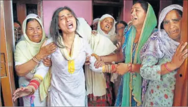  ?? PTI ?? The family of slain 20yearold soldier Satish Bhagat cry at their Jammu residence on Thursday. Bhagat and Lance Naik Ranjit Singh were killed in Pakistan’s sniper fire along the Line of Control in Kupwara on Wednesday.