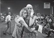  ?? EMRAH GUREL/AP PHOTO ?? Passengers embrace each other as they wait outside Istanbul’s Ataturk airport early today.