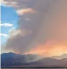  ?? RICK EGAN/THE SALT LAKE TRIBUNE VIA AP ?? Smoke from a wildfire falls over Salt Lake County on Saturday in Utah. By Sunday, the spreading fire was zero percent contained.