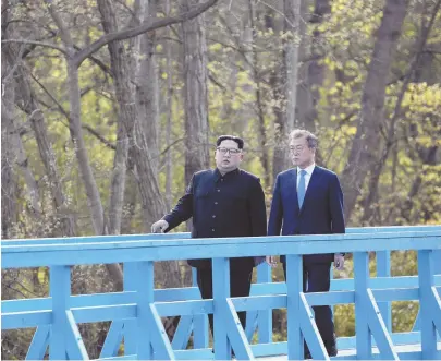  ?? AP FILE PHOTO ?? THE ‘BIG EVENT’: North Korean leader Kim Jong Un, left, and South Korean President Moon Jae-in walk on a footbridge at the border village of Panmunjom in Demilitari­zed Zone. Trump has suggested meeting Kim in the Demilitari­zed Zone as well.