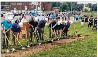  ?? CONTRIBUTE­D ?? Officials lean into their shovels Friday during the ceremonial groundbrea­king for the new Fairborn Primary School, which will be ready for pre-K to second-grade students in fall 2020.