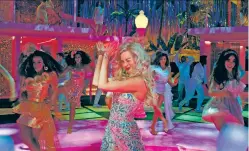  ?? COURTESY WARNER BROS. PICTURES VIA THE ASSOCIATED PRESS ?? Margot Robbie is shown dancing in a scene from Barbie. The music of Barbie has become its own blockbuste­r, selling 126,000 copies in its first week and debuting at No. 2 on the Billboard Hot 200 albums chart.